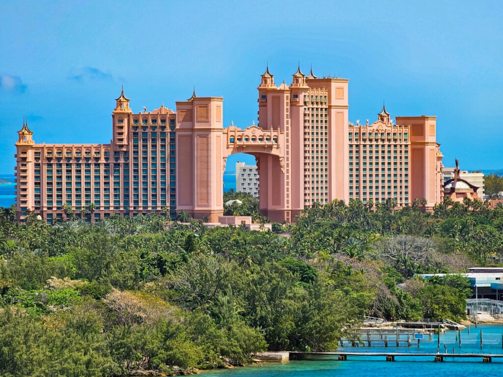 A stunning view of the iconic Atlantis Resort in Nassau, Bahamas, surrounded by lush greenery.