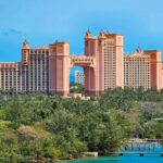 A stunning view of the iconic Atlantis Resort in Nassau, Bahamas, surrounded by lush greenery.
